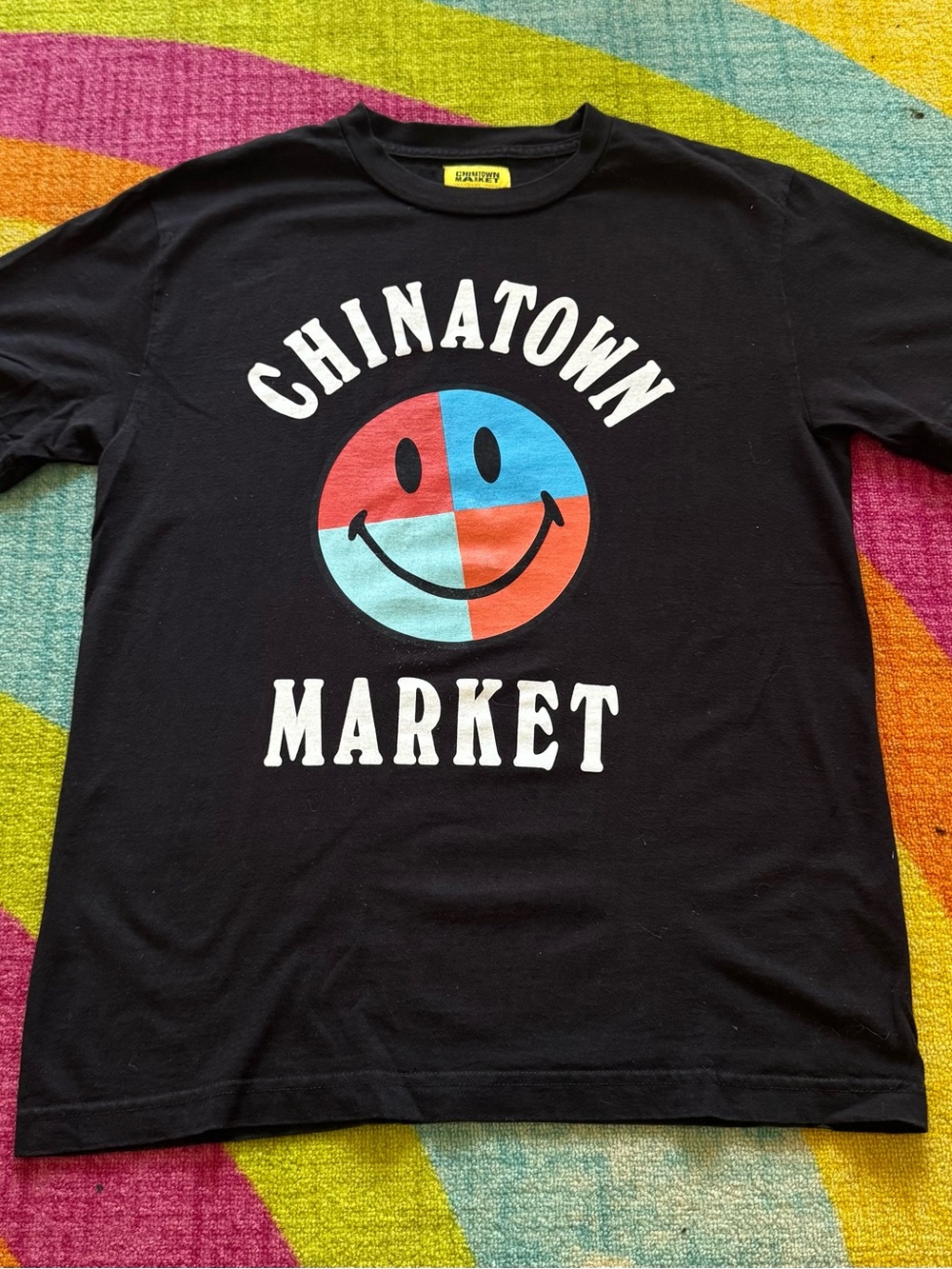 Chinatown Market Black Short Sleeve Graphic T-Shirt with Red & Blue Smiley